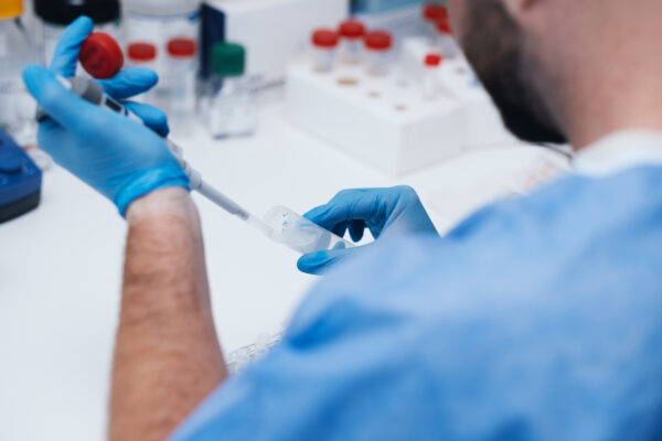 The picture of a researcher working in a lab with samples.